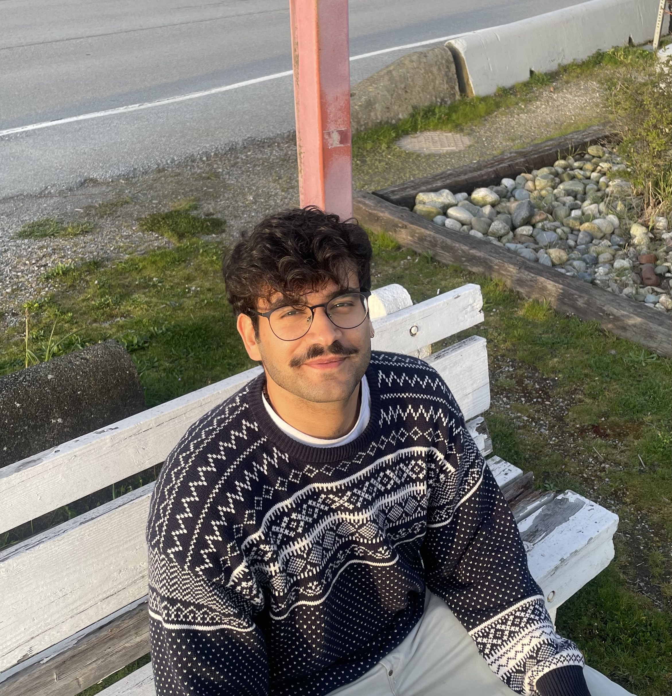 Rayyan Basheer looking up and smiling.  He wears a sweater